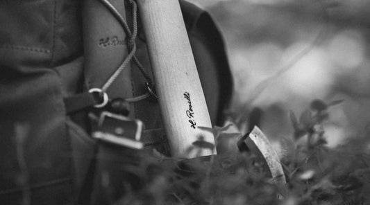 Roselli axe handle in curly birch next to backpack 